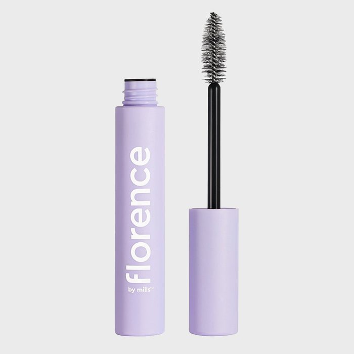 Mascara tube and brush, placed upright on a plain background. Text on the tube reads 