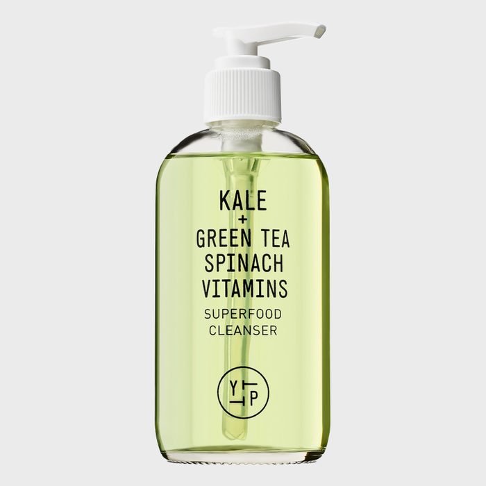 A clear bottle dispenses light green liquid, labeled 