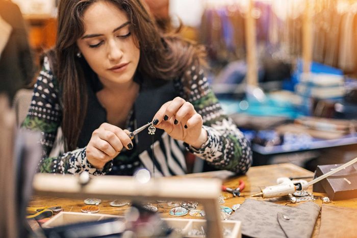 woman making jewelry