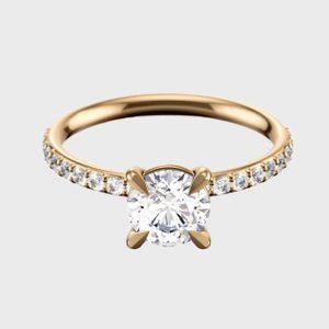 A gold ring displays a large central diamond, surrounded by smaller diamonds, on a plain white background.
