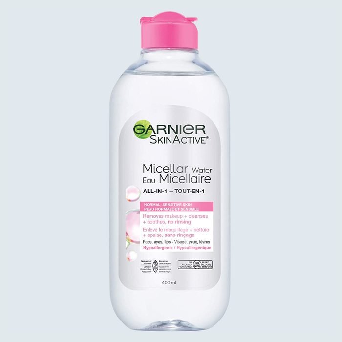 A clear plastic bottle with pink cap labeled 
