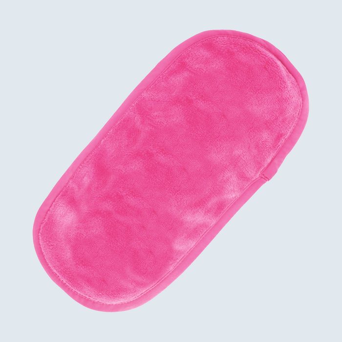 Pink padded oval object lies flat against light gray background.