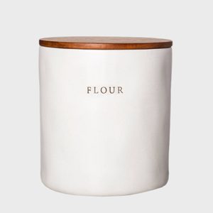 A ceramic jar with a wooden lid labeled 