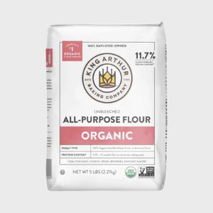 Bag of King Arthur all-purpose flour labeled organic, unbleached; suitable for various baking needs. It weighs 5 lbs and is 100% employee-owned.