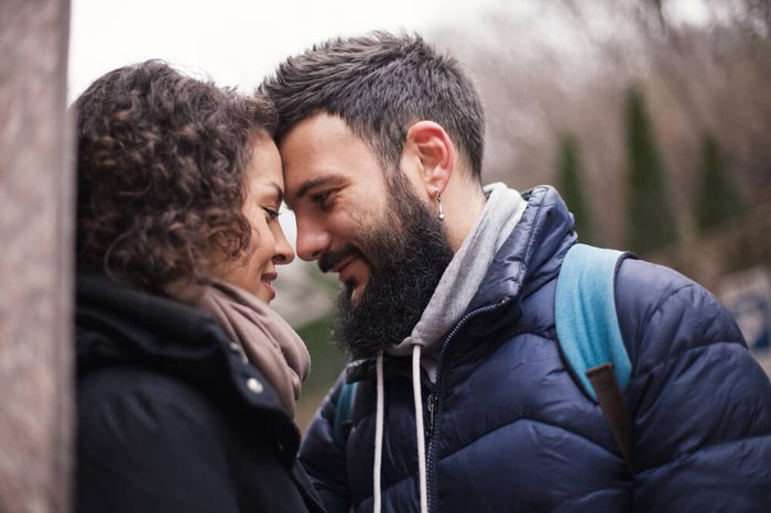 A man and a woman are looking at each other, close-up. Second before the kiss.