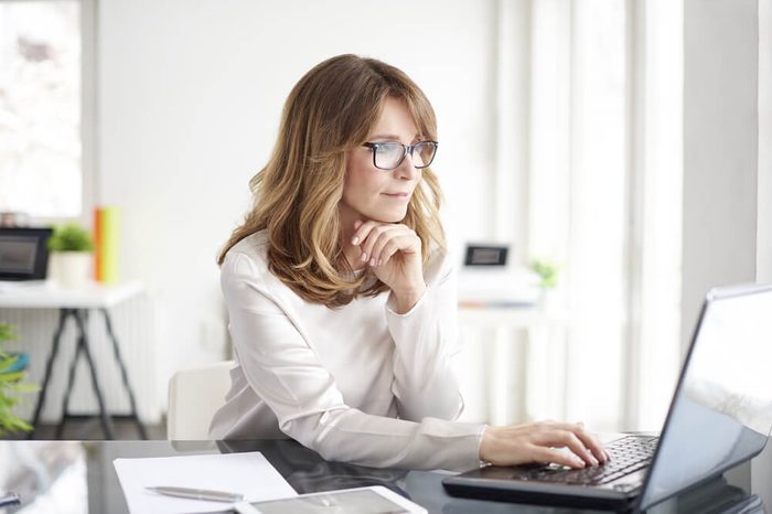 Shot of an attractive mature businesswoman working on laptop in her workstation.