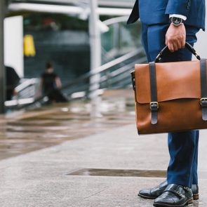 Closeup Of A Businessman Holding leather Briefcase Going To Work