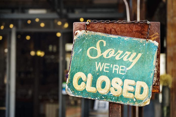 sorry we are closed sign hanging outside a restaurant, store, office or other