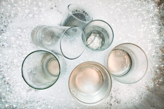 Washing dirty glasses with detergent and water