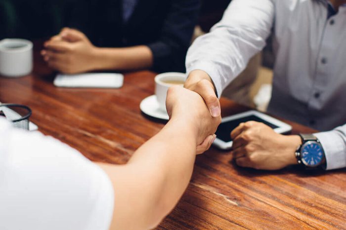 Close up portrait of businessmen shaking hands