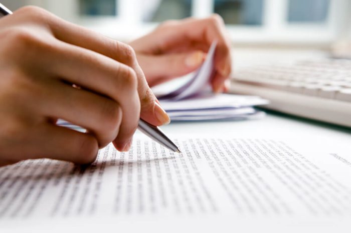 Close-up of secretary?s hands doing paperwork