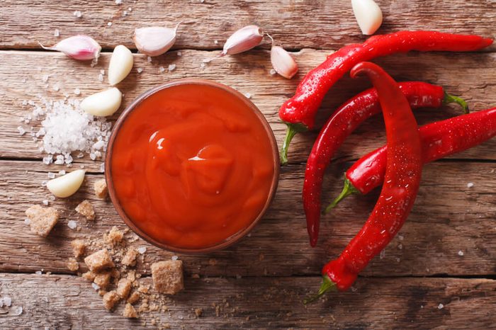 Freshly prepared Sriracha Hot chilli Sauce close-up on the table. horizontal view from above