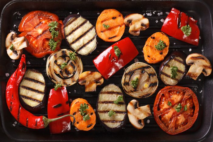 Background of grilled vegetables on a grill close up. horizontal view from above