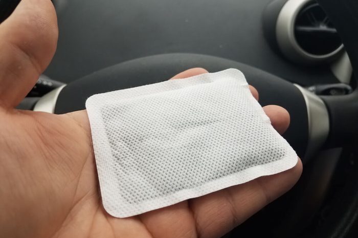 hand holding hand warmer in car