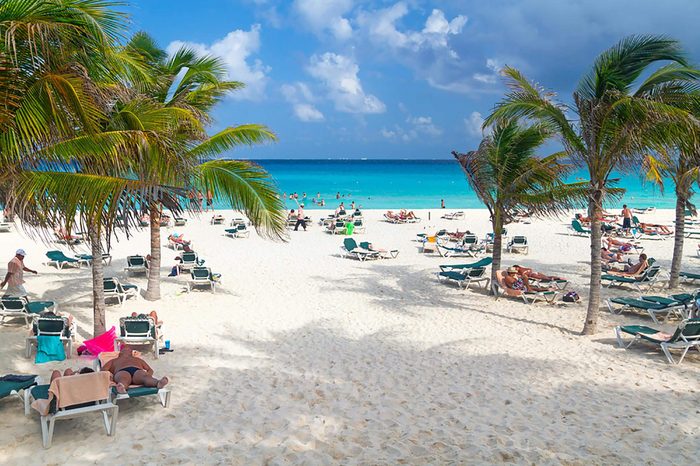 PLAYA DEL CARMEN, MEXICO - JULY 13: Unidentified tourists on the beach of Playacar at Caribbean Sea in Mexico, July 13, 2011. This resort area is popular destination with the most beautiful beaches.