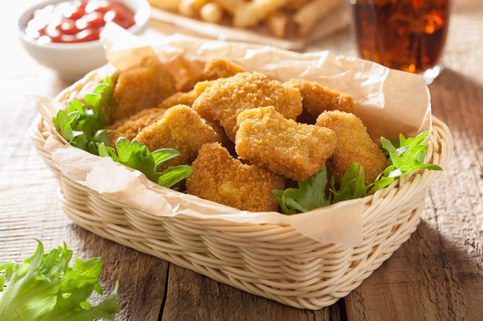 fast food chicken nuggets with ketchup, french fries, cola