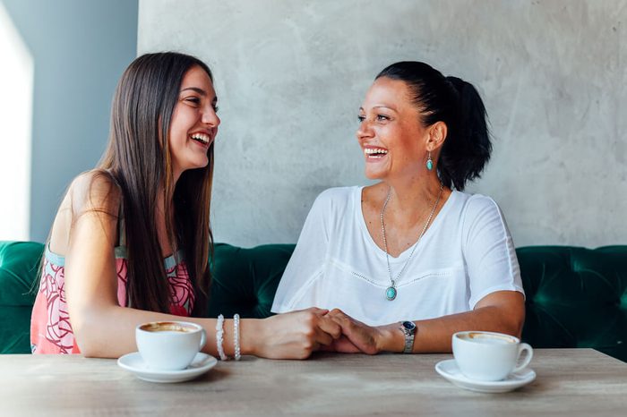 Smiling mother and daughter in a cafe
