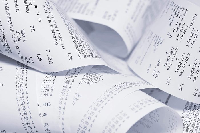 Paper cash register receipts in a lose pile close up