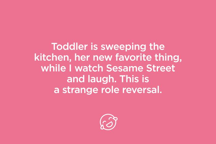 toddler is sweeping the kitchen