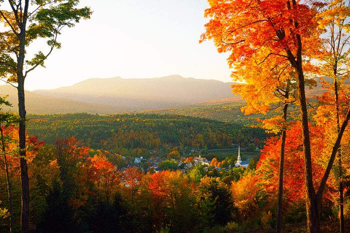 Overlooking Stowe Community Church sitting amongst the tranquil village of Stowe on a spectacular autumn sunset with Mt. Mansfield in the background, Stowe, VT, USA.