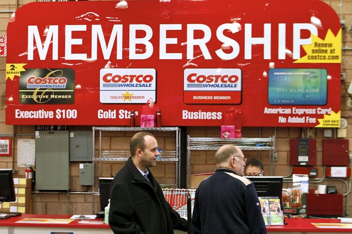 In a photo made, Consumers apply for Costco membership at the Costco Wholesale store in Glendale, Calif. Costco's fiscal third-quarter net income climbed 19 percent on lower asset charges and the wholesale club pulled in more money from membership fees