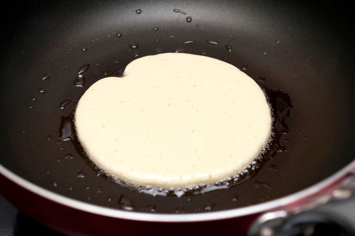 Making pancakes on frying pan