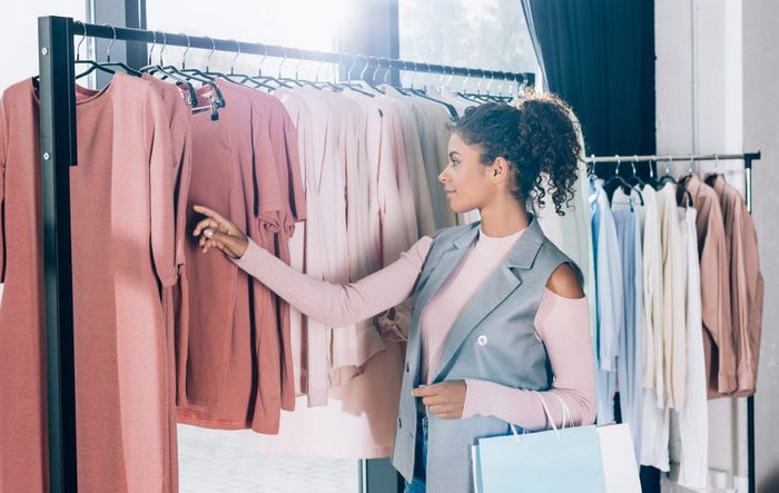 beautiful young woman on shopping in clothing store