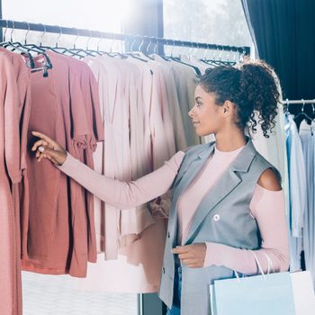 beautiful young woman on shopping in clothing store