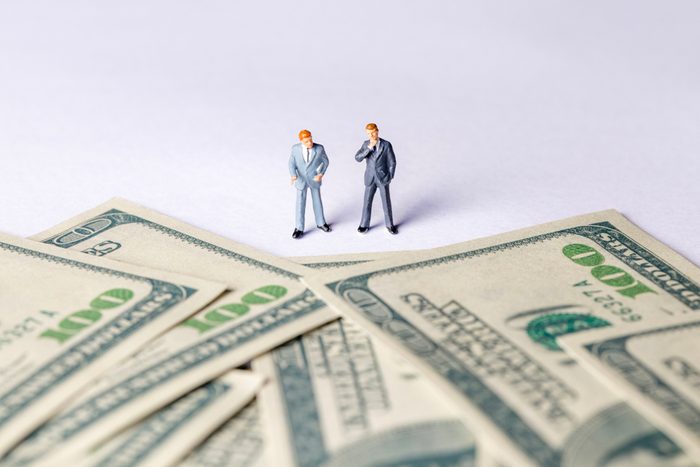 Miniature of investor man looking to money. Business and Investment concept.