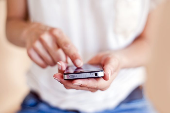 Young woman using a touchscreen smartphone.