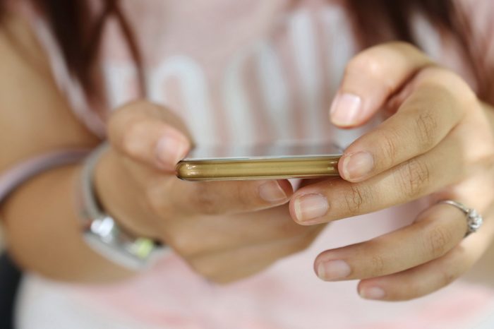 Asian woman hand use phone ,using mobile slim tablet, Internet of things lifestyle with wireless communication and internet with smart phone.business connection.