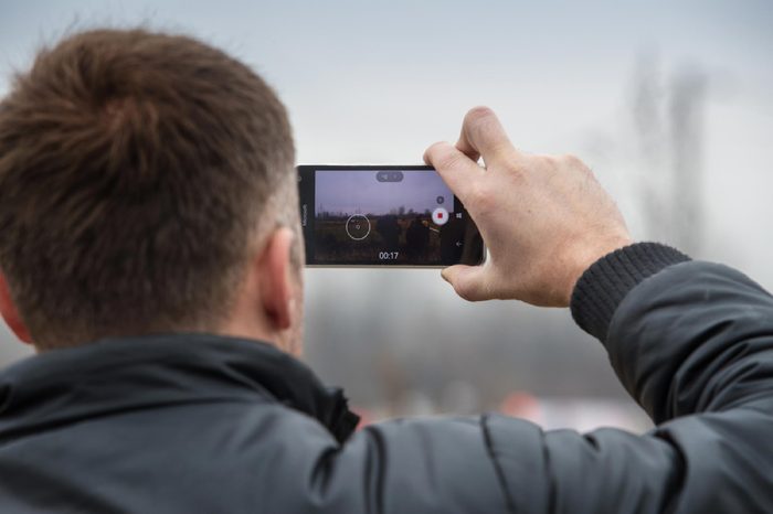 SVETA NEDELJA, CROATIA - NOVEMBER 27, 2016. 7th Rally Show Santa Domenica. Unidentified man taking video with smart phone.
