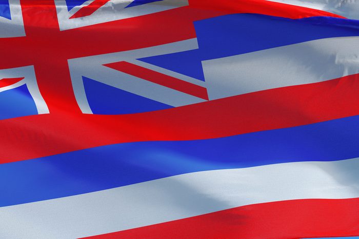 Hawaii (U.S. state) flag waving against clear blue sky, close up, isolated with clipping path mask alpha channel transparency, perfect for film, news, composition