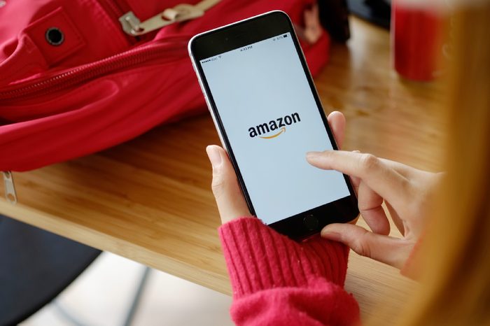 CHIANG MAI,THAILAND - NOV 18, 2017 : Woman holding iPhone 7 Plus showing Amazon apps. Amazon.com, Inc. is an American international electronic commerce company.