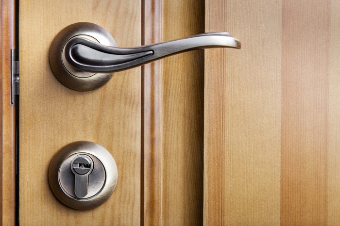 Modern style door handle on natural wooden door