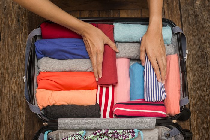 woman packing a luggage for a new journey