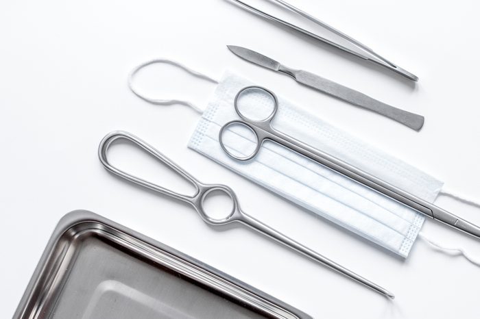 instruments for plastic surgery on white background top view