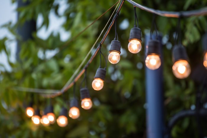 Hanging decorative christmas lights for a wedding ceremony