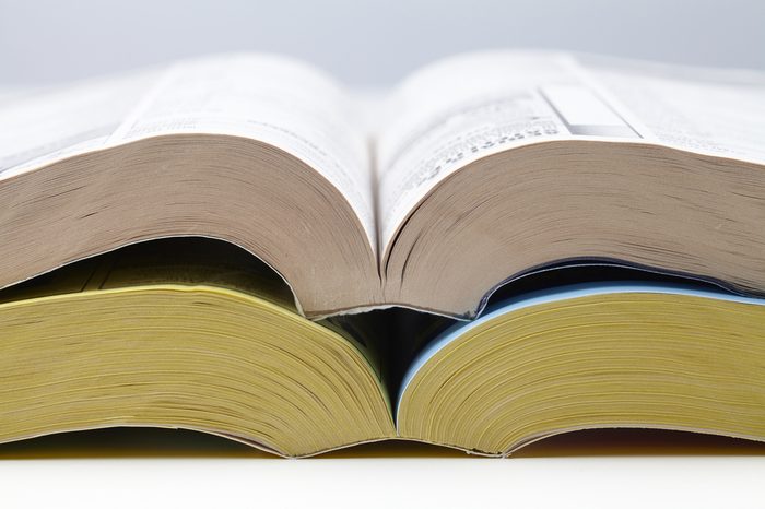 two open telephone books, one with white one with yellow pages