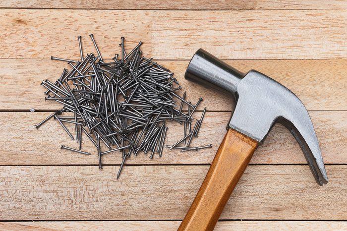 Hammer and nails on wood background