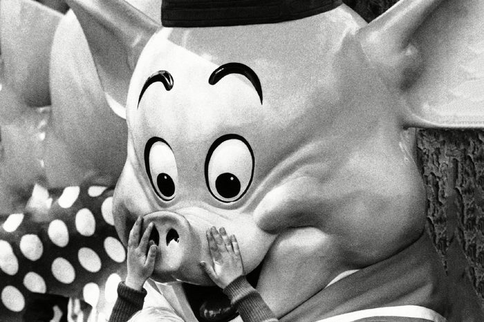 A child visiting Disneyland lovingly touches one of the "Three Little Pigs" storybook characters which abound in Disneyland at Anaheim, Calif., . The Disney characters are among the favorite attractions at the nationally famous amusement park