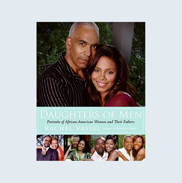A father embraces his daughter in a green outdoor setting; book titled 