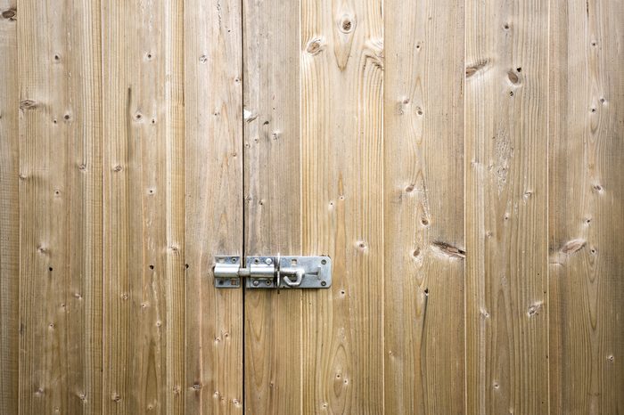 Wooden shed door with locking bolt