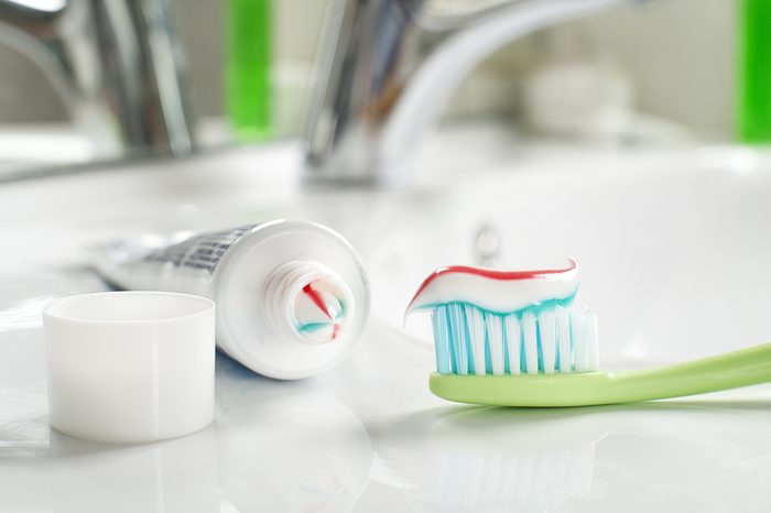 Toothbrushe and toothpaste in the bathroom close up.