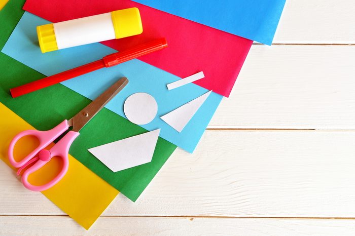 Glue stick, scissors, red marker, colored sheets, paper patterns. Set to create original summer card. Patterns for card making. Stationery. Toddler and preschool art lesson. Wooden background