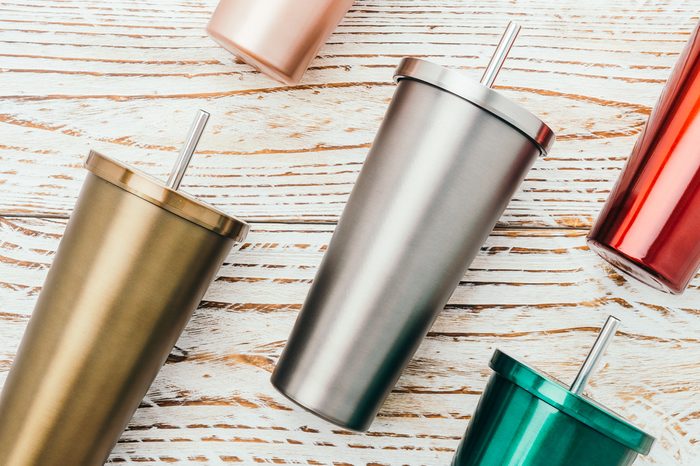 Stainless and tumbler cup on wooden background