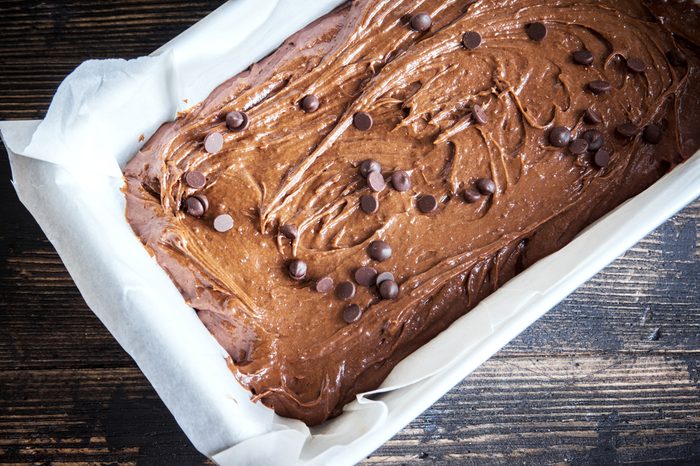 Basic homemade brownie or chocolate cake raw dough in baking pan. Cooking (baking) homemade chocolate cake or brownie.