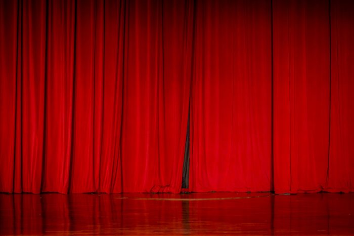 Red curtains in a theater scene of the show.