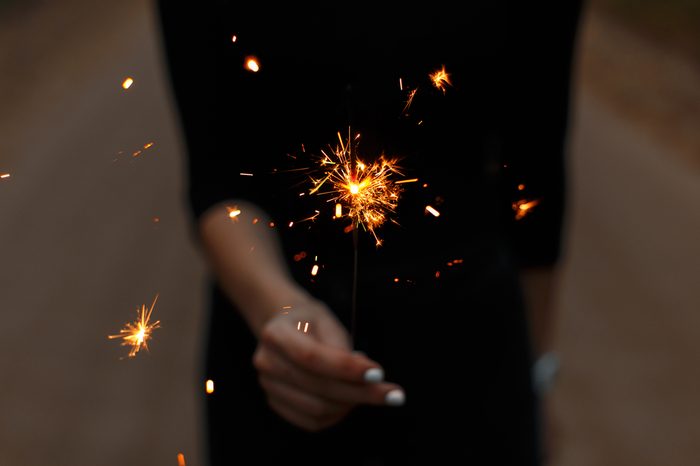 Sparkler. Female hand holding a Bengal fire