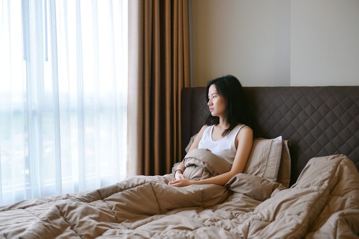 sad depressed woman thinking on bed in luxury bedroom